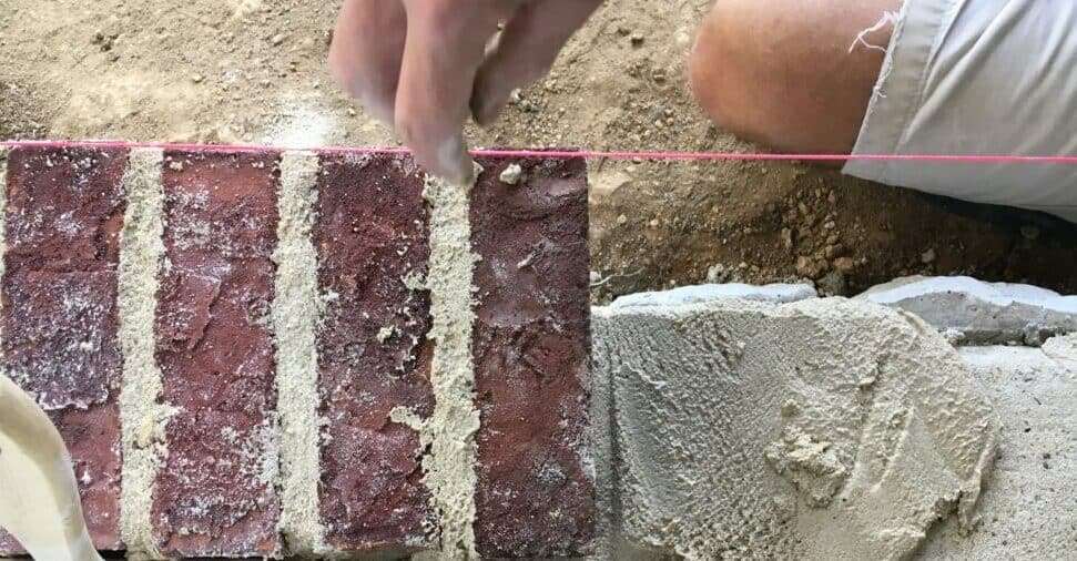 mortar bed, row of bricks, and string level